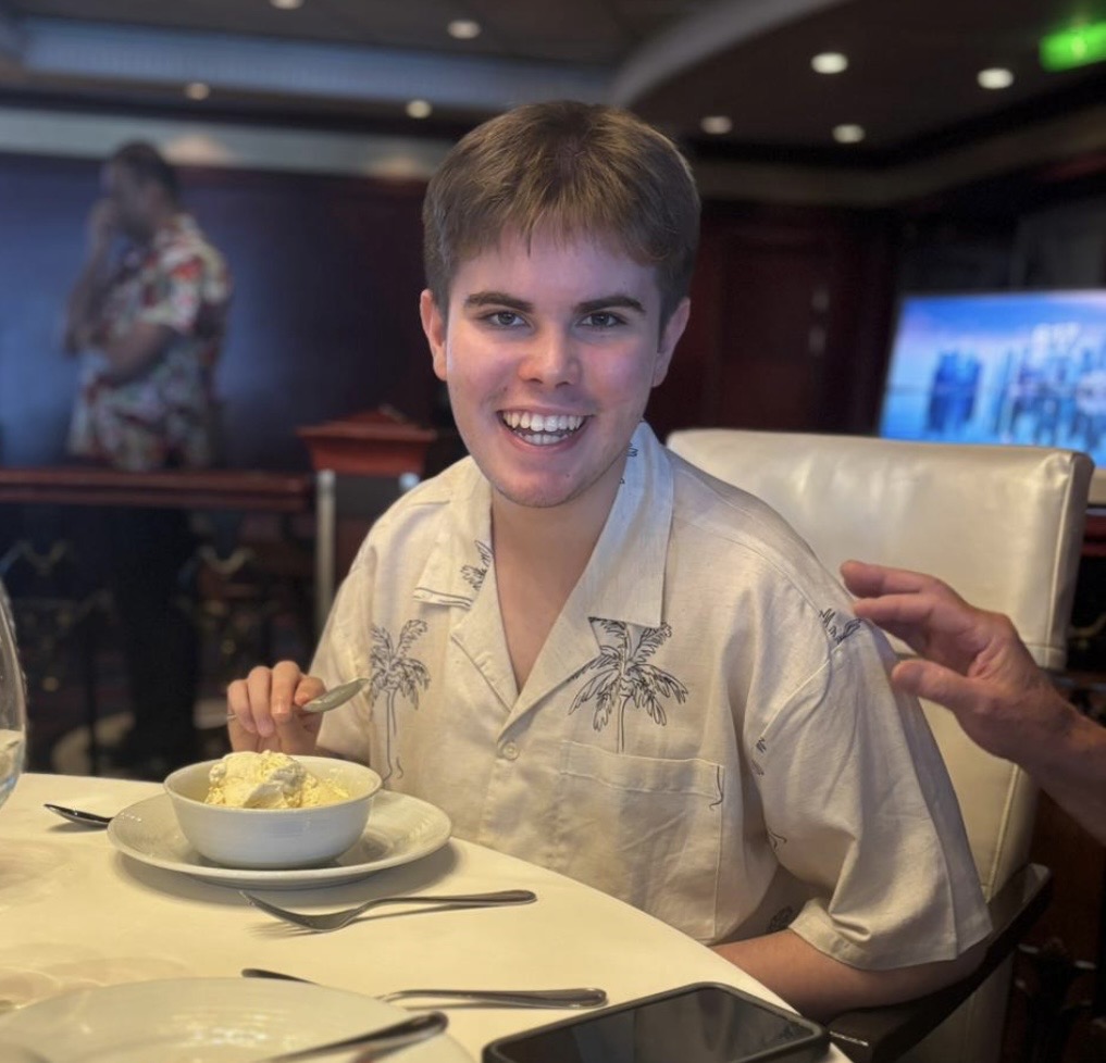 Alfie, the founder's son, smiling at a restaurant table